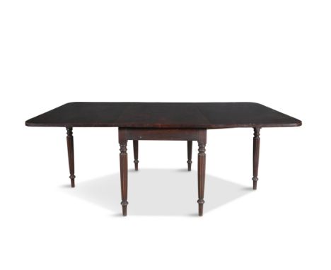 A GEORGE IV MAHOGANY DOUBLE DROP LEAF SUPPER TABLE BY GILLOWS Extending to rectangular form, the solid panel top with rounded