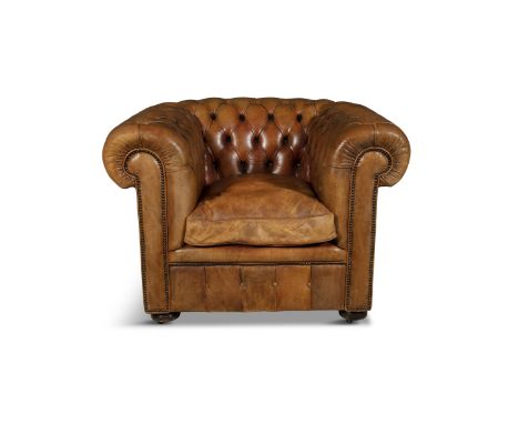 A TWO-SEAT LEATHER UPHOLSTERED CHESTERFIELD COUCH AND CLUB ARMCHAIRthe couch covered with button back upholstery and fitted w