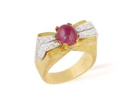 A RUBY AND DIAMOND RING, the frontispiece designed as a stylised bow centring an oval-shaped ruby cabochon between brilliant-