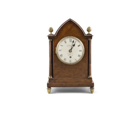 AN EDWARDIAN MAHOGANY CASED MANTLE CLOCKwith arched toop flanked by column supports surmounted with acorn finials, the circul