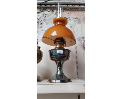 An oil lamp with glass shade. 