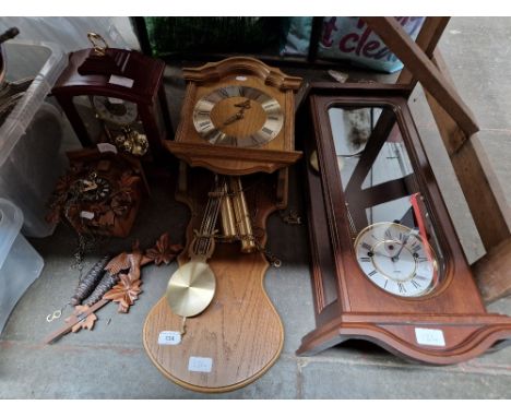 A group of assorted clocks including a cuckoo clock &amp; a granddaughter clock etc. 