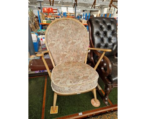 A 1960s Ercol light elm armchair. Dimensions- height 94.5cm, width 74.5cm and depth 74cm (approx).The seat is solid elm (no w