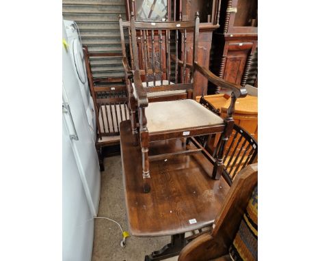 An Ercol dark elm refectory table and six chairs. 