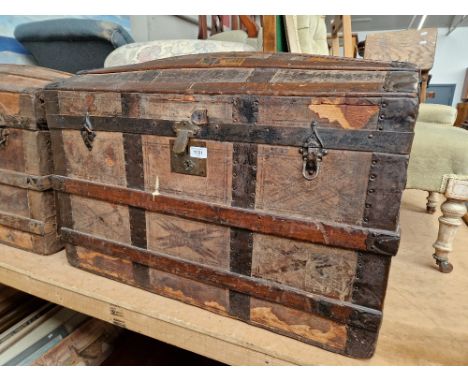 An early 20th century vintage shipping trunk with labels including E&amp;O Hotel Penang etc. 