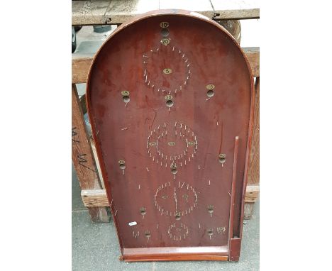A vintage bagatelle board with balls 