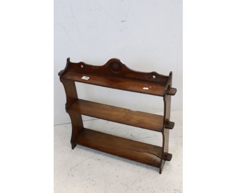 A mahogany small wall book shelf unit. 