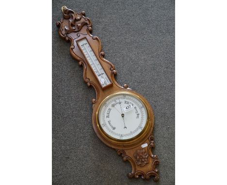 A 20th century oak cased Barometer with carved and scalloped neck. 