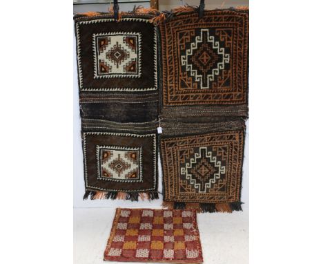 Two Afghanistan Wool Double Carpet Camel Bags, 108cms x 46cms and 122cms x 50cms together with a Persian Cushion Cover 