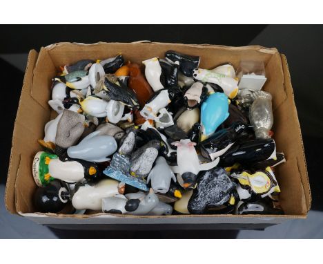 A large collection of ornamental penguins to include ceramic examples. 
