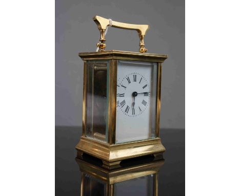 A vintage brass cased carriage clock with white enamel dial, complete with key. 