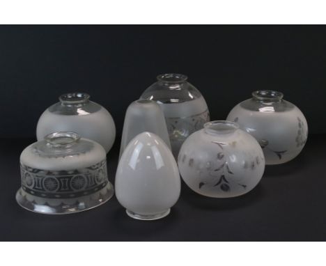 A collection of seven glass lamp shades. 
