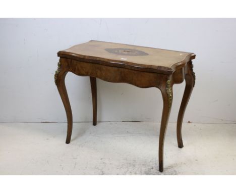 19th century French Walnut Fold-over Card Table, the shaped top with floral marquetry inlay (a/f) opening to a circular red b