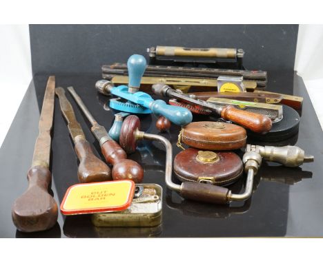 A collection of vintage tools to include Drills, Chisels, Tapes and levels. 