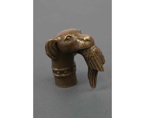 A walking stick handle in the form of a gun dog with gamebird in its mouth. 