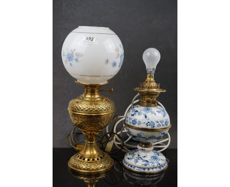 A blue &amp; white "Blue Onion" patterned china lamp converted to electric together with a ornate brass lamp with white shade