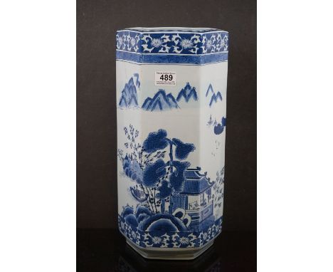 A contemporary blue and white hexagonal Chinese stick stand with figures in a garden setting signed with square character mar