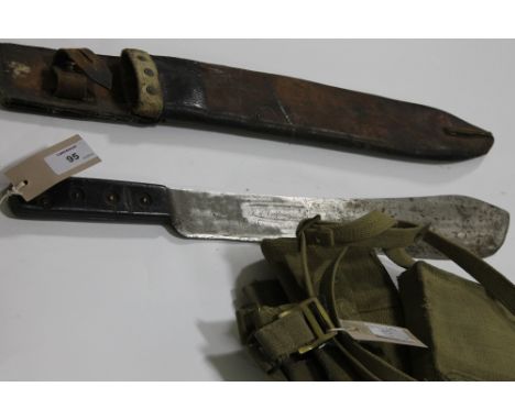 A MACHETE etc. A Jungle Machete by Martindale of England no 227, complete with leather scabbard. Marked on the blade E8277-19