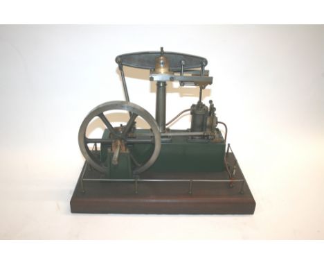 STUART MODEL STEAM ENGINE - BEAM ENGINE a model beam engine with a single flywheel on a cast iron base, with a wooden plinth 