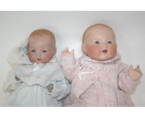 ARMAND MARSEILLE DOLLS two dolls, Model 351 with fixed blue eyes and open mouth. Also with a larger version Model 351 with we