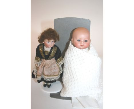 SCHOENEU & HOFFMEISTER BABY DOLL a small doll with weighted blue eyes and closed mouth. Also with a small bisque head by Unis