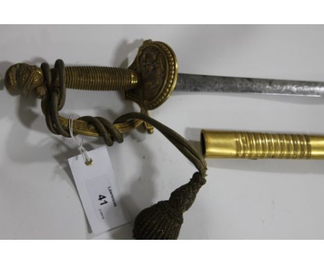 A COURTSWORD. A Ceremonial or Courtsword, with gilt mounts and swordknot. Helmet pommel and stirrup hilt-guard quard decorate