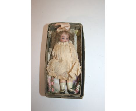 MINIATURE BISQUE HEAD DOLL with weighted blue eyes and open mouth. 13cms long