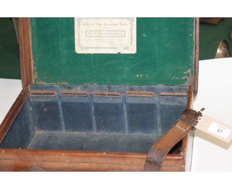 A PARTIAL CARTRIDGE MAGAZINE. A leather covered partial cartridge magazine, lacking divider and top straps. Army & Navy label