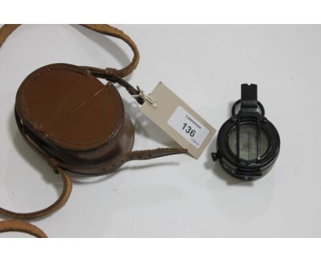A MILITARY COMPASS. A blackened Stanley sighting compass in good order, in a fitted leather case and straps.
