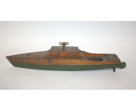MODEL BOAT - CLOCKWORK a lovely wooden model boat with metal propeller. Operated by a clockwork mechanism, and with it's key.
