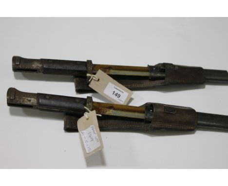 TWO MAUSER BAYONETS. Two 1903 model knife bayonets, complete with steel scabbards and leather frogs.
