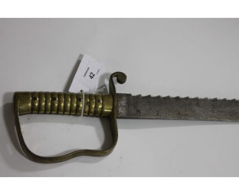 A WILKINSON SAWBACK SIDEARM. A Wilkinson London 1856 pattern Pioneer 'sawback' sidearm, with brass hilt and 22.1/2" blade. Wi