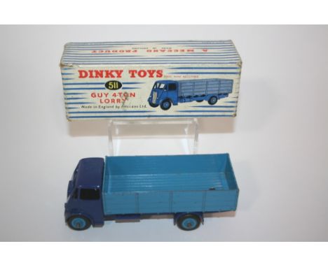 DINKY TOYS - GUY 4 TON LORRY Model Number 511 Guy 4 Ton Lorry, with a dark blue cab and light blue flat bed. In it's box.