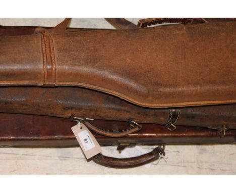 A LEATHER GUN CASE & LEG OF MUTTON CASES. A brown leather shotgun case, lacking its entire innards. The name on the top is Du