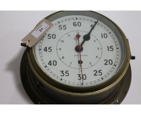 A BRASS NAVAL CLOCK. A brass Ships clock with white 7.1/2" dial, second hand and outer 60 second scale. The red second hand c