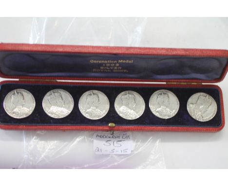 CASED 1902 CORNATION MEDALS/BUTTONS Six silver Royal Mint 1902 Coronation medals with button backs, in a fitted red leather l