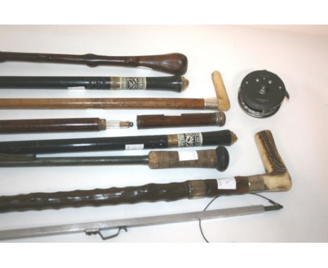 WALKING STICKS & FISHING ITEMS including a walking stick which unscrews to reveal a glass bottle inside, an ivory handled wal