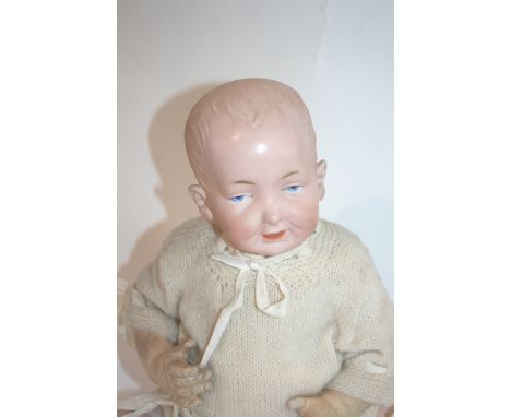 BISQUE GERMAN CHARACTER DOLL an interesting doll with painted eyes and mouth, and moulded hair. With a bent limb body, marked