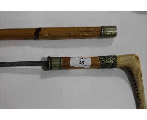 A SWORDSTICK. A bone handled swordstick in cane mounts. Hollow ground triangular rapier style blade of 25" in length. With ea