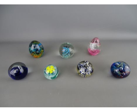 Seven vintage glass paperweights