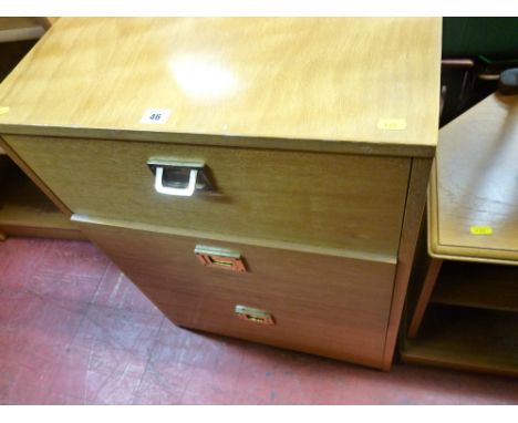 Light wood three drawer filing cabinet with brass handles