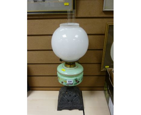 Iron based oil lamp with green milk glass shade