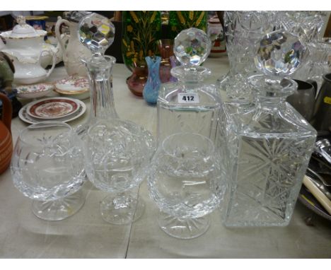 Ship's type decanter and two square decanters, all with stoppers, two brandy glasses and one other