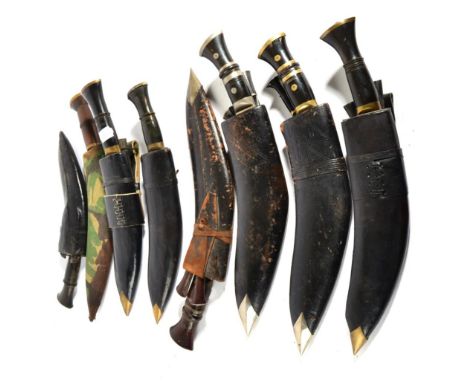 A Collection of Six Kukris, each with horn hilt, nickel bolster and butt cap, with leather scabbard, one with blade stamped  