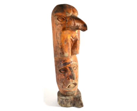A Large Pale Wood Totemic Figure, possibly American Indian, carved from a single trunk as the head of a stylised eagle over t