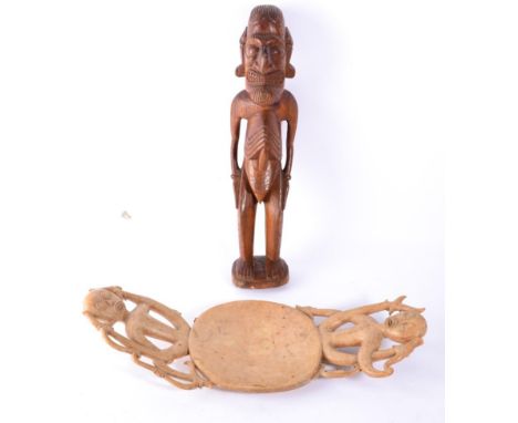 A South Sea Islands Light Wood Platter, the slightly dished circular bowl with two splayed handles pierced and carved as styl
