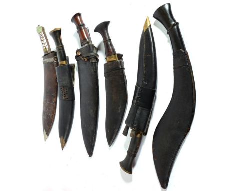 An Indian Kukri, with 30cm round back blade, steel recurving crossguard, the greenstone and mother of pearl hilt with ring po