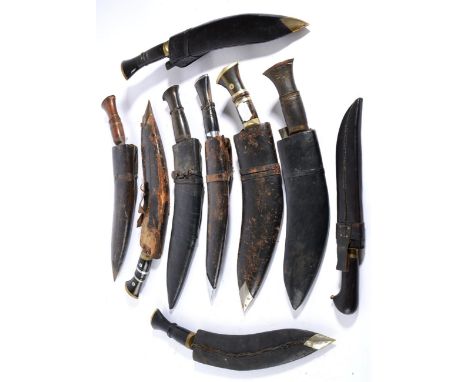 An Indian Kukri, the 32cm blade with two broad shallow fullers and a narrow fuller to the back edge, the horn grip with steel