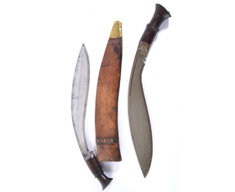 A British Military Issue Kukri, the 34cm curved steel blade with two broad shallow fullers and two deep fuller to the back ed