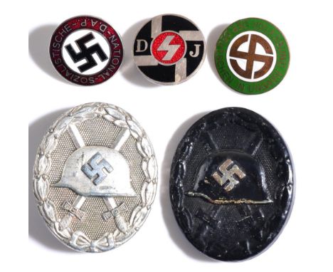 A German Third Reich Wound Badge, Silver Class, the flat back with maker's number 65 and with vertical needle pin; another Bl